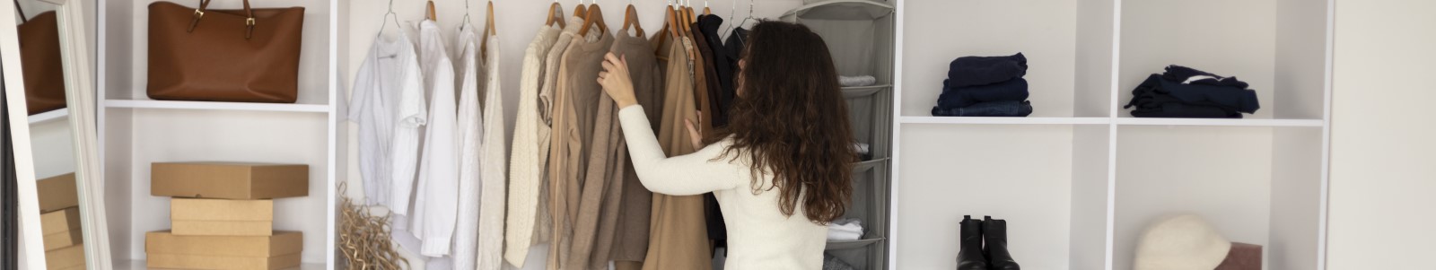 Professional organizers arranging clothes and storage in a modern custom closet design